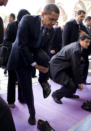 President Barack Obama removes his shoes as he prepares to visit the Blue Mosque April 7, 2009, in Istanbul. President Barack Obama removes his shoes as he prepares to visit the Blue Mosque April 7, 2009, in Istanbul. White House Photo, by Pete Souza.