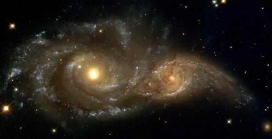 A grazing encounter between two spiral galaxies. Billions of years in the future, these galaxies will collapse into one larger galaxy. It is believed that most galaxies are formed in this way. NASA Photo