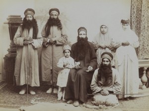 Family of Dervishes A Family of Dervishes. Possibly Antoin Sevruguin (Armenian-Georgian, 1830s–1933). Iran, late 19th–early 20th century. Silver albumen photograph. Brooklyn Museum, Purchase gift of Leona Soudavar in memory of Ahmad Soudavar, 1997.3.139. A Sufi’s attributes and clothing indicate the mystical order to which he or she belongs and may also suggest rank and status within that order. Here, the patriarch’s black robe emphasizes his authority. The varied styles of the hats further delineated positions within the group. The central seated figure holds a tabar, a small ceremonial axe, while each of the remaining men holds a walking staff, another iconic Sufi attribute. The extremely long beards of the male members identify this group as part of the Ahl-i Haqq order of Sufis, whose practices are guarded with extreme secrecy. The photograph may have been taken by Antoin Sevruguin, who served at the court of the Qajar ruler Nasir al-Din Shah in the latter nineteenth century and who is known for his portraits of Iranian landscapes and subjects.