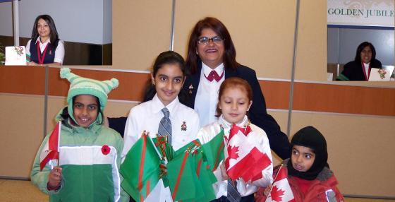 A collage of Ismaili volunteers. Centre group - Ottawa Ismaili Junior volunteers with their mentor; Two insets - part of a volunteer team serving at the Toronto Pearson International Airport during the Golden Jubilee of His Highness the Aga Khan.Photo: Malik Merchant.