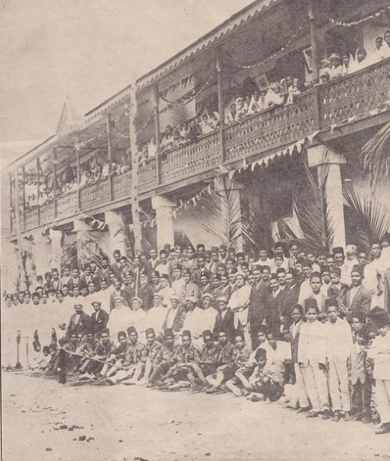 A large gathering outside the Zanzibar Jamatkhana witnessing the raising of the Ismaili Flag.