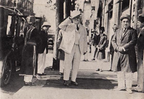 His Highness the Aga Khan pictured during his arrival at Aimila Automobile, Bombay, and being received by Husenali Mitha, standing at right.