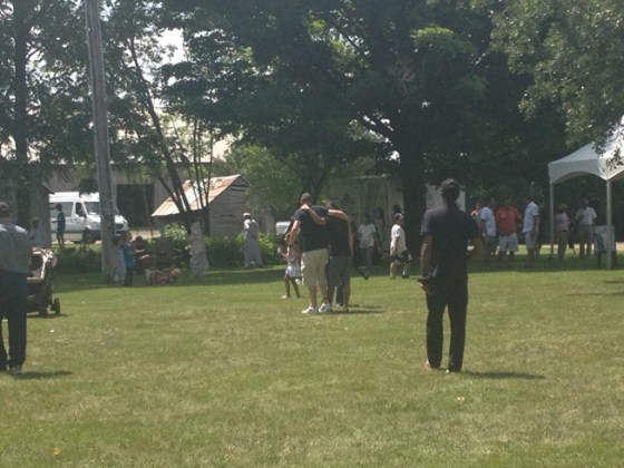 Two jamati members can be seen from a distance, practicing their coordination in preparation for a three-legged race