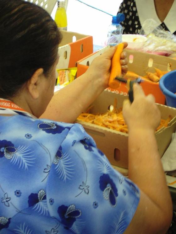 A volunteer peeling carrots.