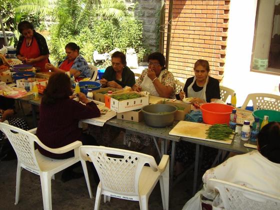 Volunteers hard at work, with some taking a deserved break from chopping and peeling vegetables.