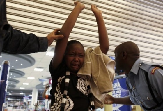 A girl is helped by police officers inside the mall. Please click on next image, see below, for a slide show at the Denver Post website. Links are also provided to the websites of Al-Jazeera and the Washington Post.