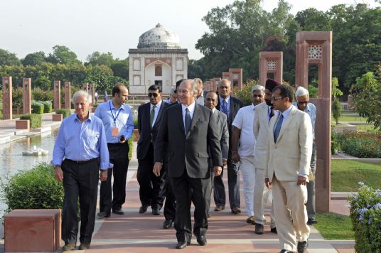 Mawlana Hazar Imam, accompanied by Prince Hussain and officials from the Aga Khan Trust for Culture, including its General Manager, Luis Monreal, front left, walks down the central axis of the Sundar Nursery — once known as Azim Bagh (great garden) —after visiting the Sundar Burj, a 16th century tomb restored by the AKTC. Photo: AKDN/Gary Otte