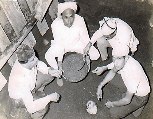 The foundation being laid of the new Daman jamatkhana on 16th Oct. 1970, with a glass jar containing a gold coin, a silver coin, documents and important dates.