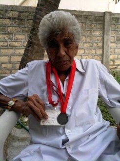 Long serving Ismaili, 77 year old farmer Gulamhusen Alibhai Jamani of Mahuva, India, with a  medal that was presented him during Volunteer Day. Please click on image for story.