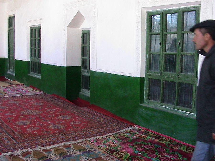 The foyer of the jamatkhana in Tashkurgan, with the Khalifah at the right. Photo: Ghulam Panjwani Collection. Copyright. 