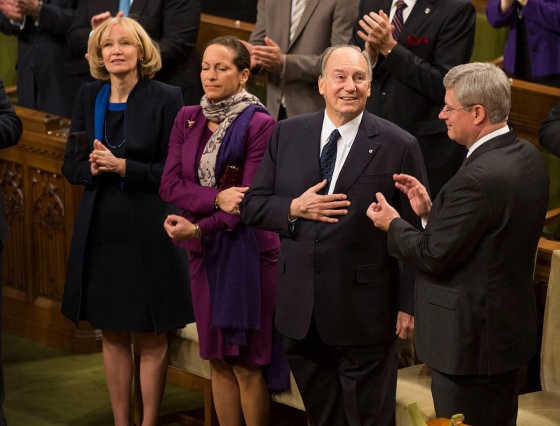 An expression of gratitude and humility by His Highness the Aga Khan as he accepts a standing ovation at the Canadian Parliament on Thursday February 24, 2014. Prime Minister Stephen Harper is seen applauding, with Princess Zahra, the daughter of His Highness, and Laureen Harper, the Prime Minister's wife, standing alongside the 49th Ismaili Imam. Photo credit: The Office of the Prime Minister of Canada