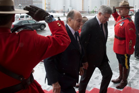 Officers of the Royal Mounted Canadian Police Salute as His Highness the Aga Khan and Prime Minister Harper walk up the stairs at Parliament Hill on Thursday, February 24, 2014. COC Photo by Jason Ransom