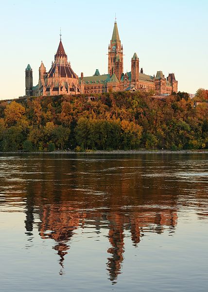 Photo of the Centre Block and Library of the Parliament of Canada from the Gatineau side, overlooking the Ottawa River. Photo: Wikipedia.