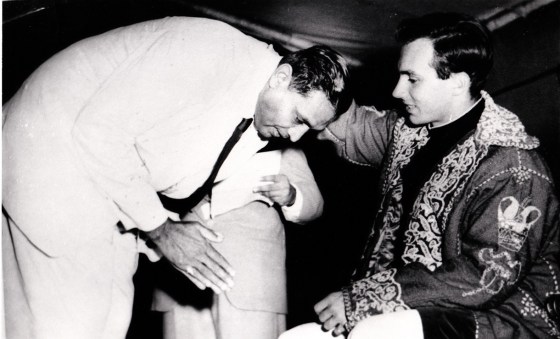 Mawlana Hazar Imam, His Highness the Aga Khan, blessing Vazier Rajabali Meghji Visram during his visit to Dar-es-Salaam, Tanzania (then Tanganuika) in October 1957. Phooto: Sadru Meghji Collection, Toronto. Please click on photo to enlarge)