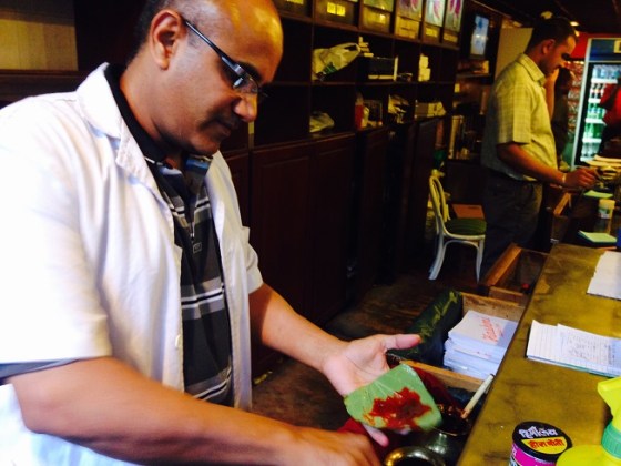 Farouk Panwalla preparing a sweet paan with a red paste. Photo: Shariffa Keshavjee.