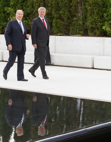 Mawlana Hazar Imam, His Highness the Aga Khan, and Canadian Prime Minister Stephen Harper, seen walking past the water pond of the Park located between the Ismaili Centre and the Aga Khan Museum during the opening ceremony in September 2014 of the two cultural landmarks built by the 49th Ismaili Imam. Photo: The website of the Prime Minister of Canada, www.pm.gc.ca. 