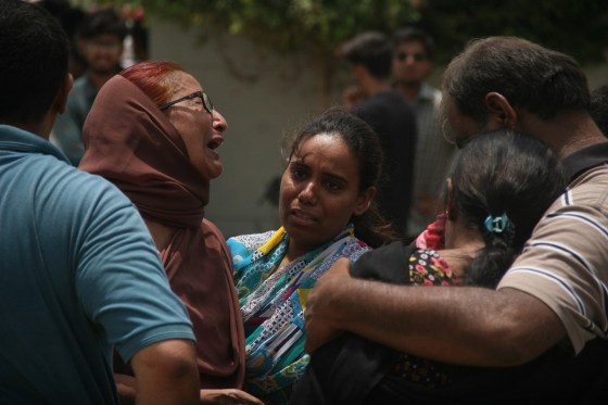 KARACHI, PAKISTAN - MAY 13: Relatives of injured and killed cry and wait outside a hospital following a gun attack on a bus carrying members of Ismaili Shia community, in Karachi, Pakistan, 13 May 2015 that killed at least 45 people including over a dozen women and injuring more than 14 people. (Photo by Sabir Mazhar/Anadolu Agency/Getty Images)