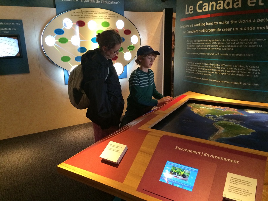 A youth takes the time to view the interactive global map and test out his knowledge. Photo: Malik Merchant/Simerg