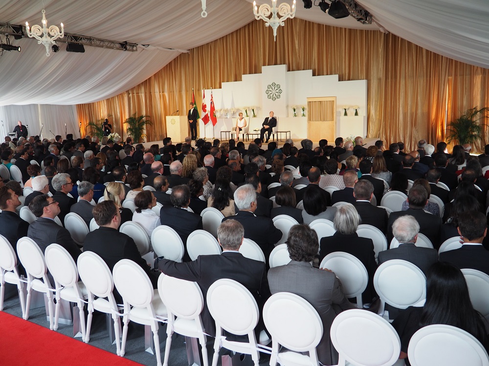 Mawlana Hazar Imam, Premier Kathleen Wynne and the reciter of the Holy Qur'an, Ahsan Afzally, look on as a translation of the Qur'anic verses in English and French is underway. Photo: Simerg/Malik Merchant. Copyright.