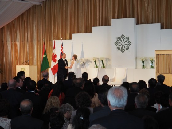 Mwlana Hazar Imam receives a standing ovation as he is congratulated by Premier Kathleen Wynne after the completion of his speech at the opening of the Aga Khan Park on May 25, 2015. Photo: Simerg/Malik Merchant. Copyright.