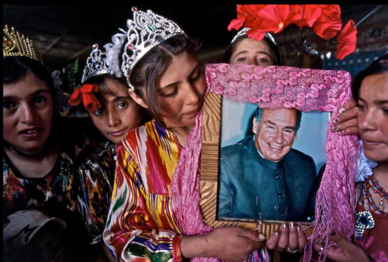 The photo was taken during Didar (Invitation) – a celebration that takes place on 28th of May every year to commemorate the anniversary of the Aga Khan’s visit to the village in the 1990s. During the celebrations the villagers dress up, dance outdoors to the accordion and drums and sing ginane (religious songs), which tell of him being their Noor (light). The photograph was taken as these girls, dressed in bright atlas silk fabric with crowns on their heads, were going out to dance. Photo: Matthieu Paley. Copyright.
