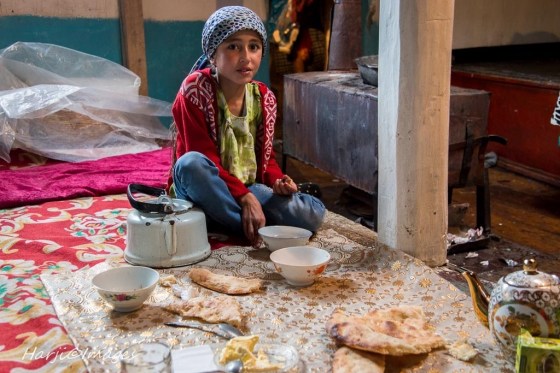 Muslim Harji's portrait of an Ismaili girl in the Wakhan Corridor of Badakhshan. She is seen Little Suranoor having breakfast before getting ready for school in the Village of Namadgut. 