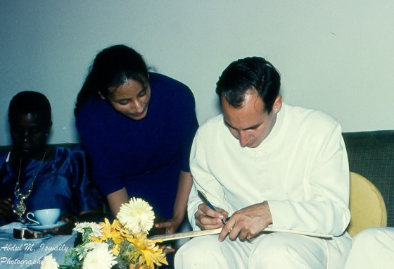 Mawlana Hazar Imam, His Highness the Aga Khan, 49th Imam of Shia Imami Ismaili Muslims, signing an autograph for Roshan Dhanani, Kampala. 