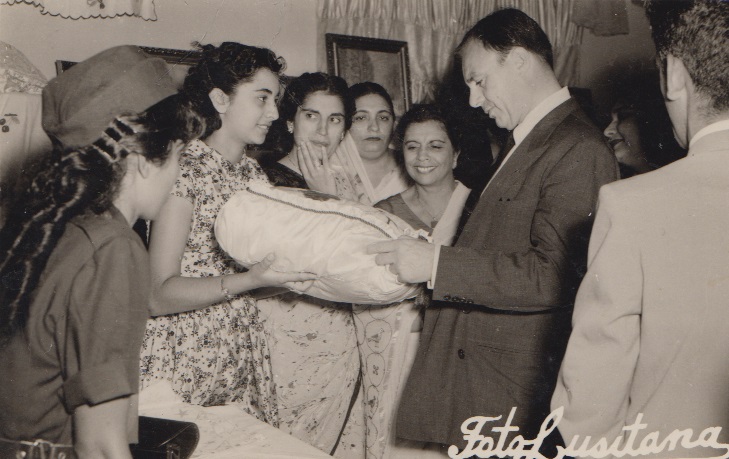 Prince Aly Khan admiring a needlework by an Ismaili Student during his visit to Lourenco Marques