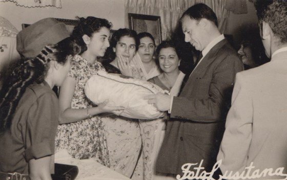 Prince Aly Khan admiring a needlework by an Ismaili Student during his visit to Lourenco Marques