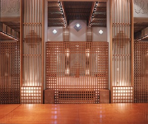 Interior view of a beautifully designed Jamatkhana with wooden elements and soft lighting, creating a peaceful and spiritual atmosphere.