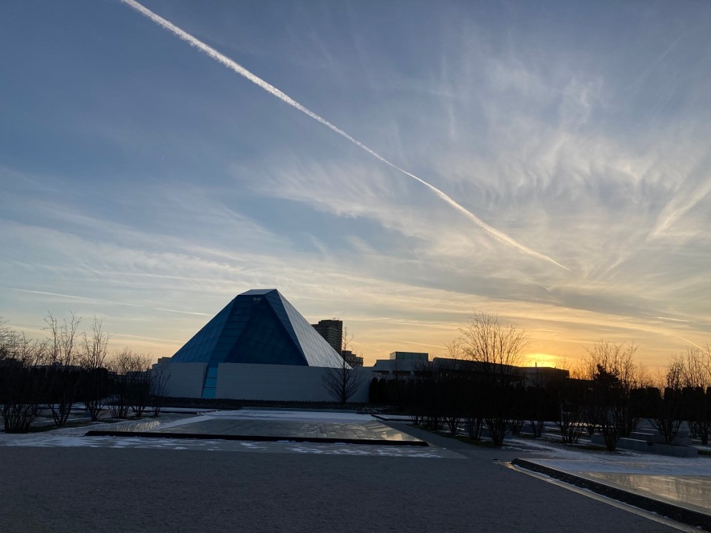 View of the Aga Khan Museum with a sunset backdrop and wispy clouds in the sky.