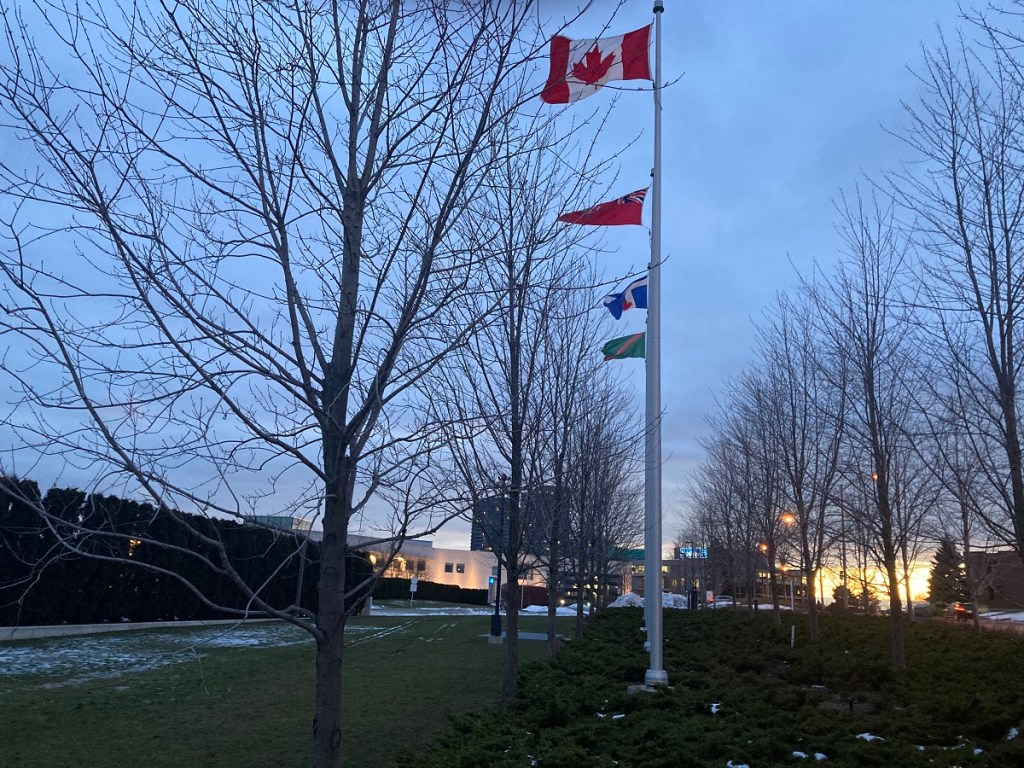 Flags of Ismaili Imamat, Canada, Ontario and Toronto at Aga Khan Park on December 31, 2020.