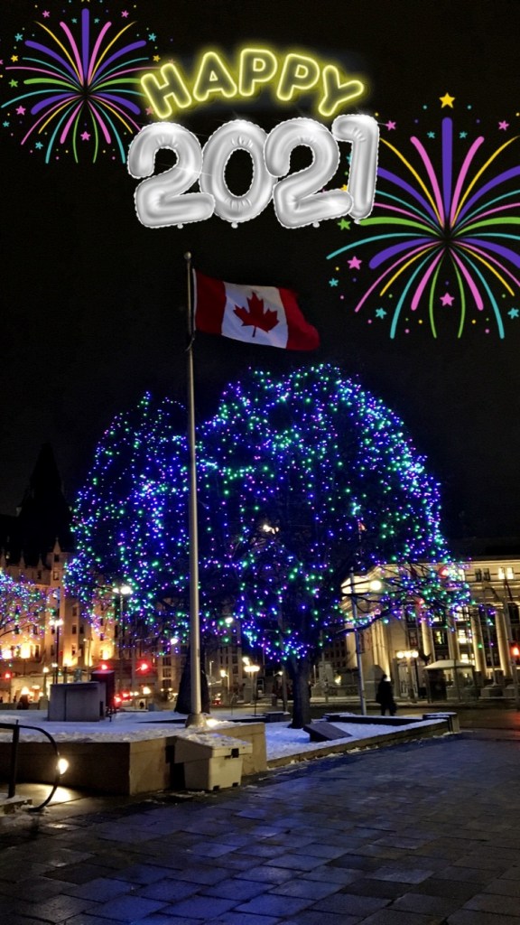 A festive night scene in downtown Ottawa, featuring a Canadian flag and a tree adorned with colorful blue and green lights. The background includes illuminated buildings and fireworks graphics celebrating New Year 2021.