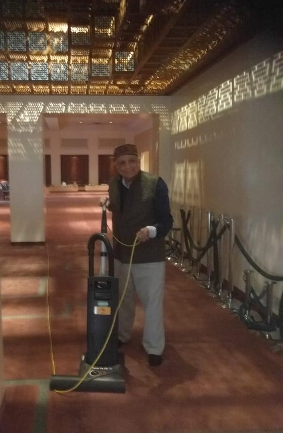 Sadru Velji vacuuming Ismaili Jamatkhana Photo: © Sadruddin Velji Family Collection.