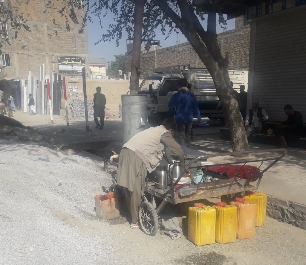 A man uses a makeshift carrier for providing tea drinking service at Kabul's Kote Sangi commercial hub sector of the city