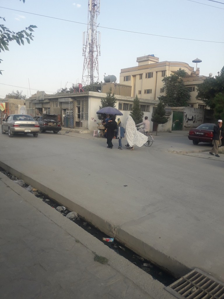Women walking on a street in Kabul's Qala-e-Fathullah neighbourhood.