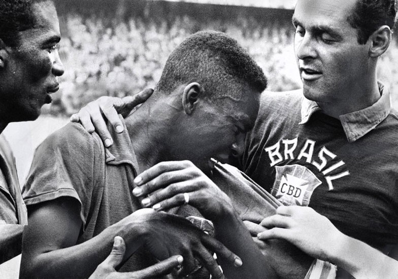 17-year-old Pelé cries on the shoulder of goalkeeper Gilmar after Brazil won the 1958 World Cup final. Photograph" Wikipedia/Public domain.