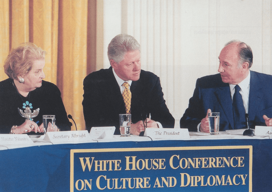 Image of a panel discussion at the White House Conference on Culture and Diplomacy featuring prominent figures including Secretary Madeleine Albright, President Bill Clinton, and His Highness the Aga Khan.