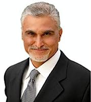 Portrait of Azim Jamal, an author and motivational speaker, wearing a suit and tie, smiling at the camera.