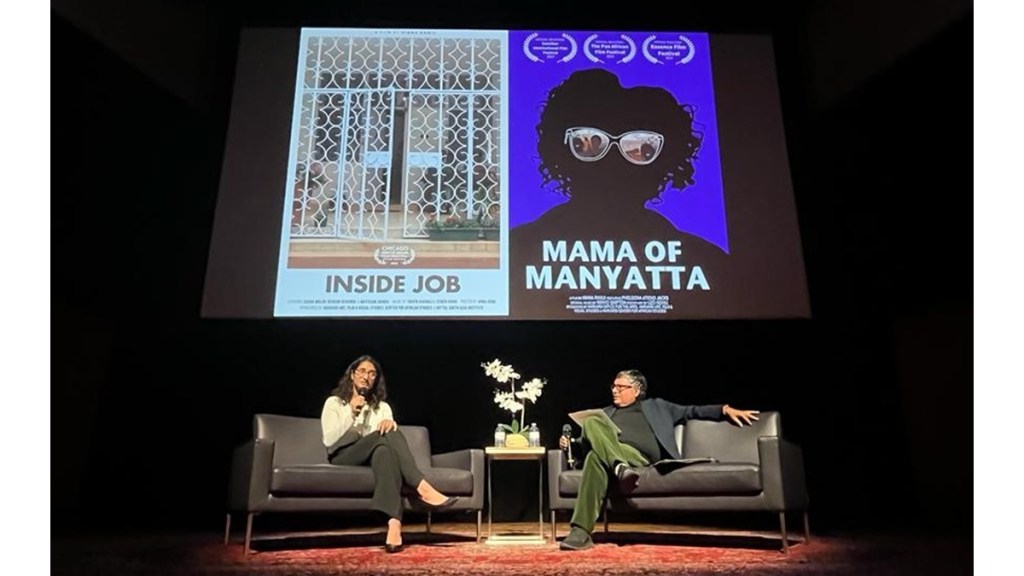 A filmmaker and a moderator sit on stage in front of a screen displaying the posters for the films 'Inside Job' and 'Mama of Manyatta' during a film screening event.