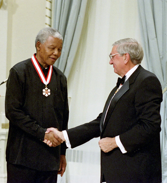 Nelson Mandela is invested as an Honorary Companion of the Order of Canada by the Late Right Honourable Roméo LeBlanc, 25th Governor General of Canada, on September 24, 1998.